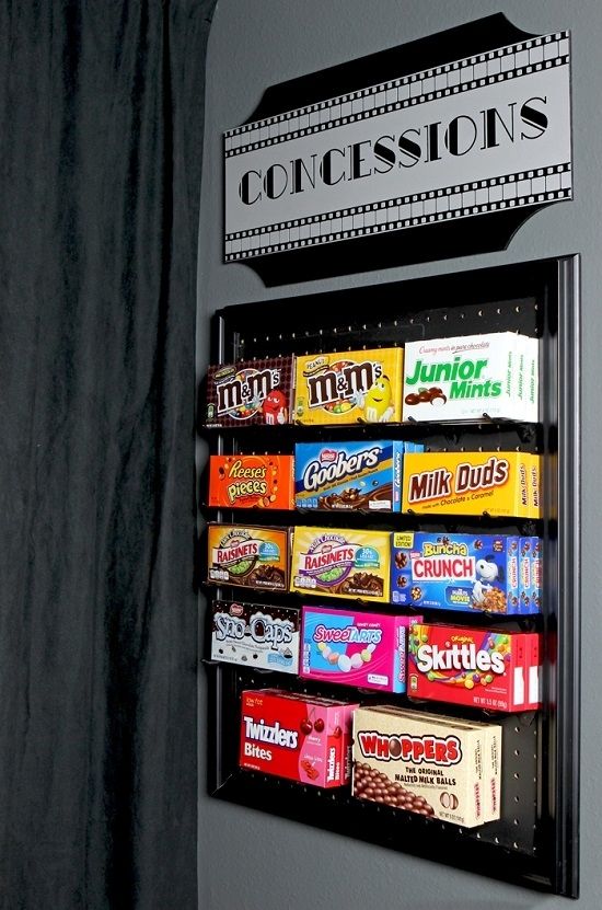 a vending machine that has some candy on the front and side of it,