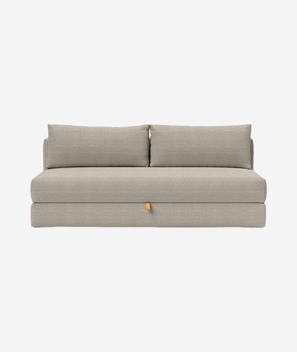 a gray couch with two pillows on it and one arm folded up to the side