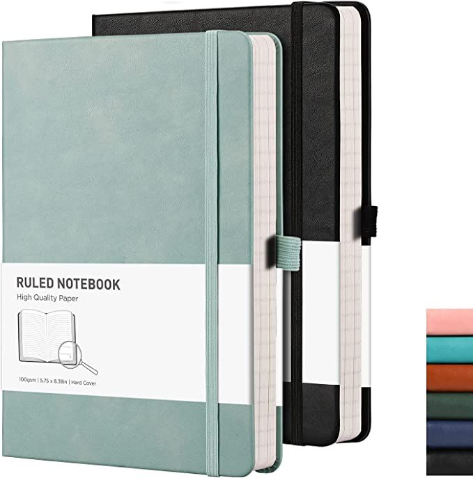 a notebook is open and sitting next to several different colored books on a white background