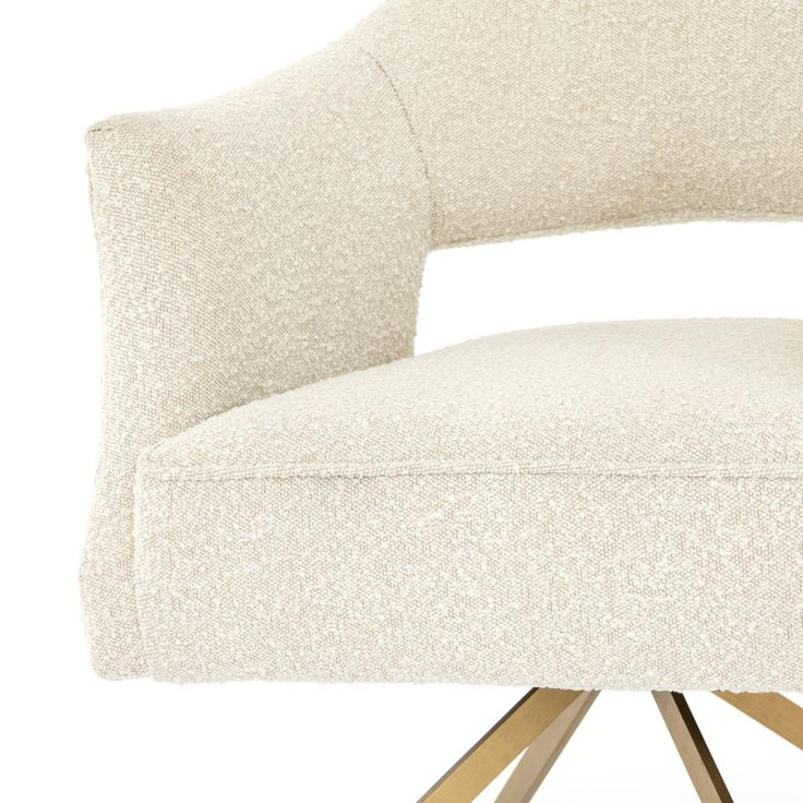 an upholstered white chair with wooden legs