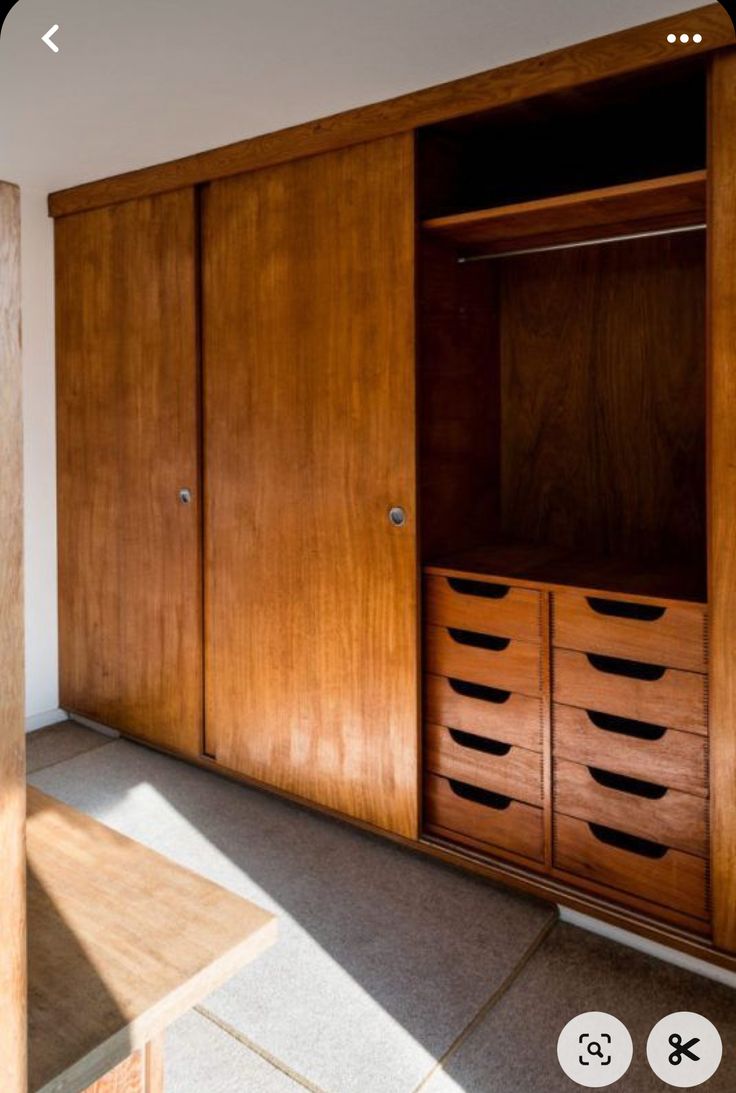 an empty room with wooden cabinets and drawers