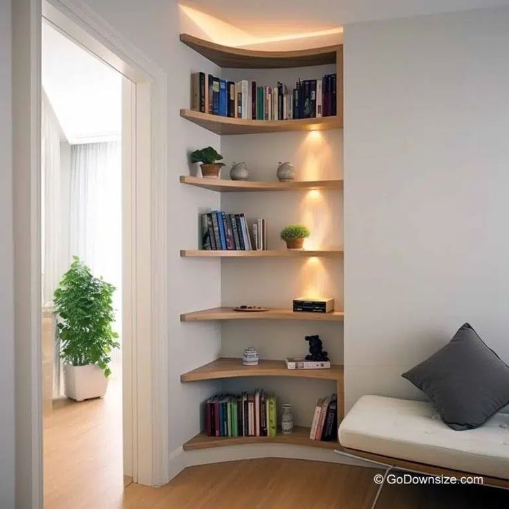 a living room filled with furniture and bookshelves next to a doorway leading to a bedroom