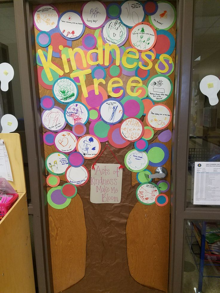 a bulletin board with the words kindness tree on it in front of a classroom door