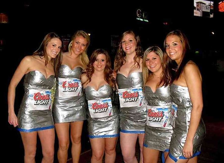 a group of women in silver dresses standing next to each other