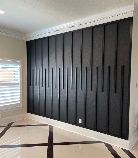 an empty room with black and white tiles on the floor