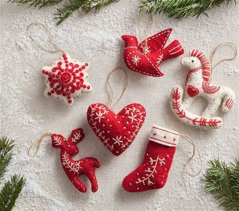 some ornaments are hanging on a white table