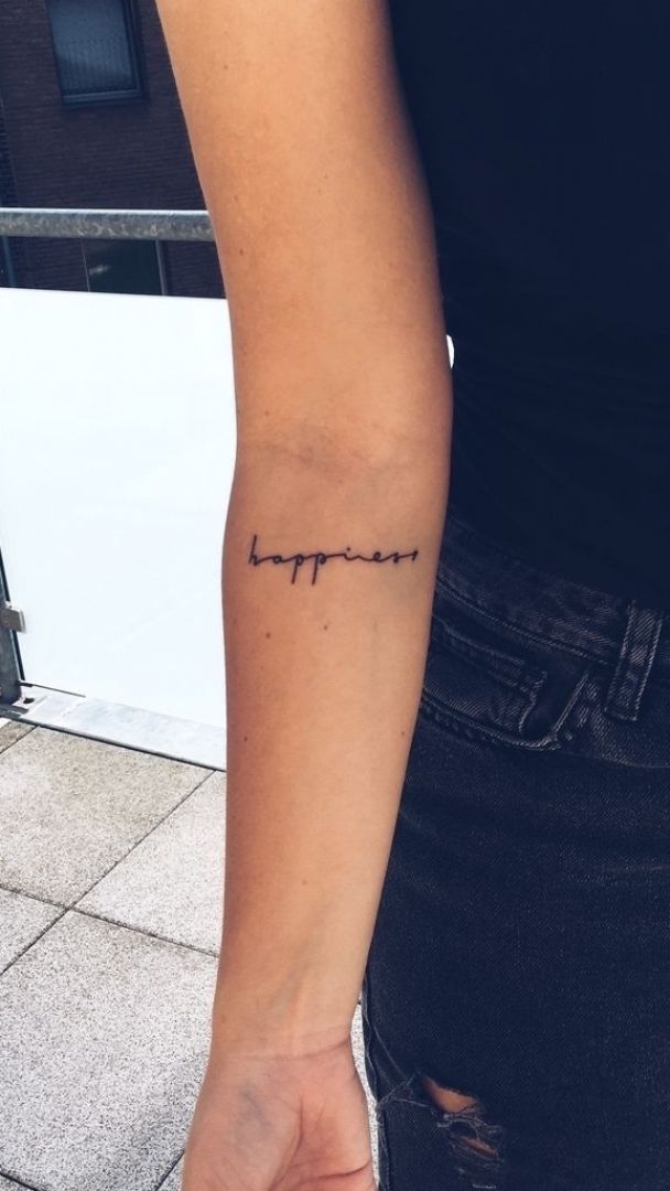 a woman with a small tattoo on her arm that says, i love you in cursive writing