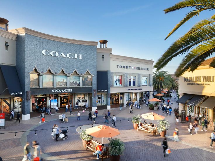 an artist's rendering of a shopping center with people walking and sitting on benches