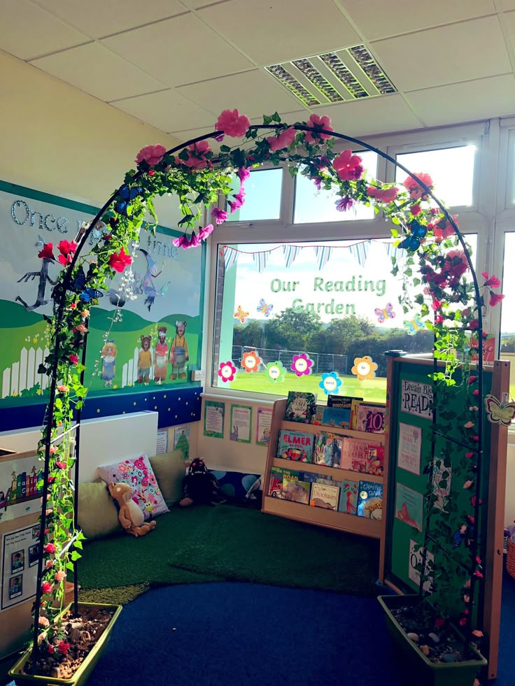 an indoor reading area decorated with flowers and greenery for children's book week