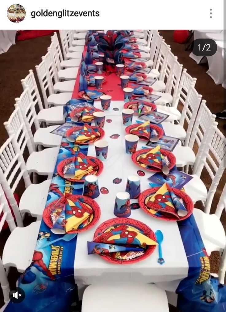 the table is set up with spiderman plates and napkins for an awesome birthday party