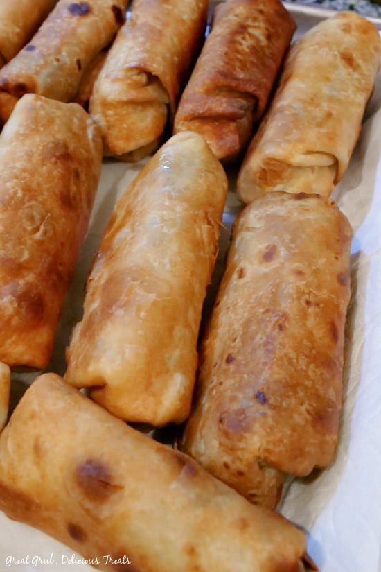 several different types of pastries sitting on top of a white paper wrapper next to each other