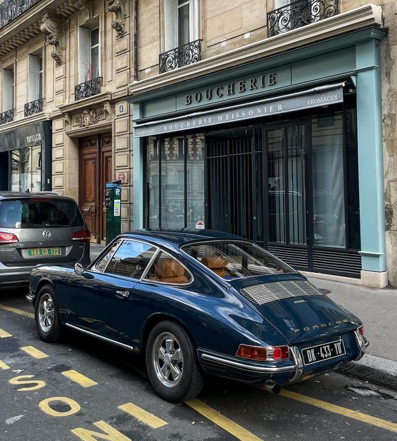 a blue car parked on the side of a street