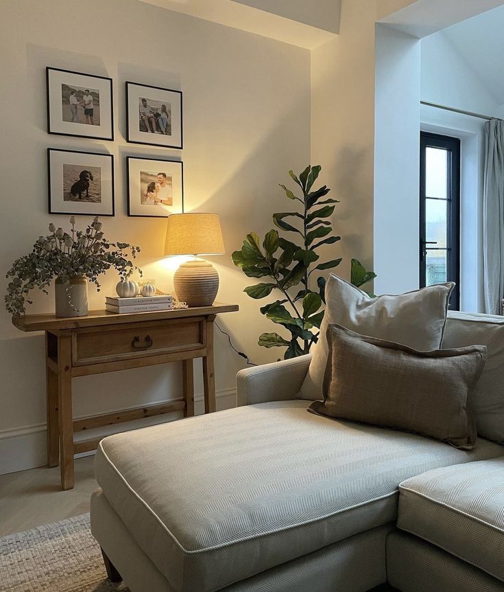 a living room filled with furniture and pictures on the wall