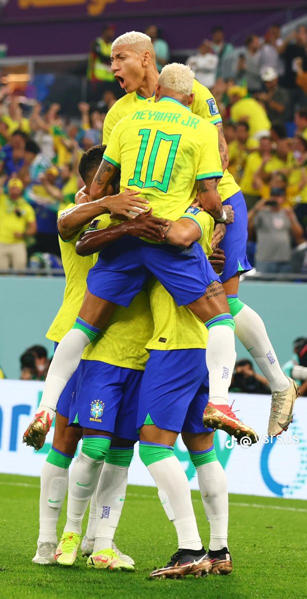 the soccer players are hugging each other on the field