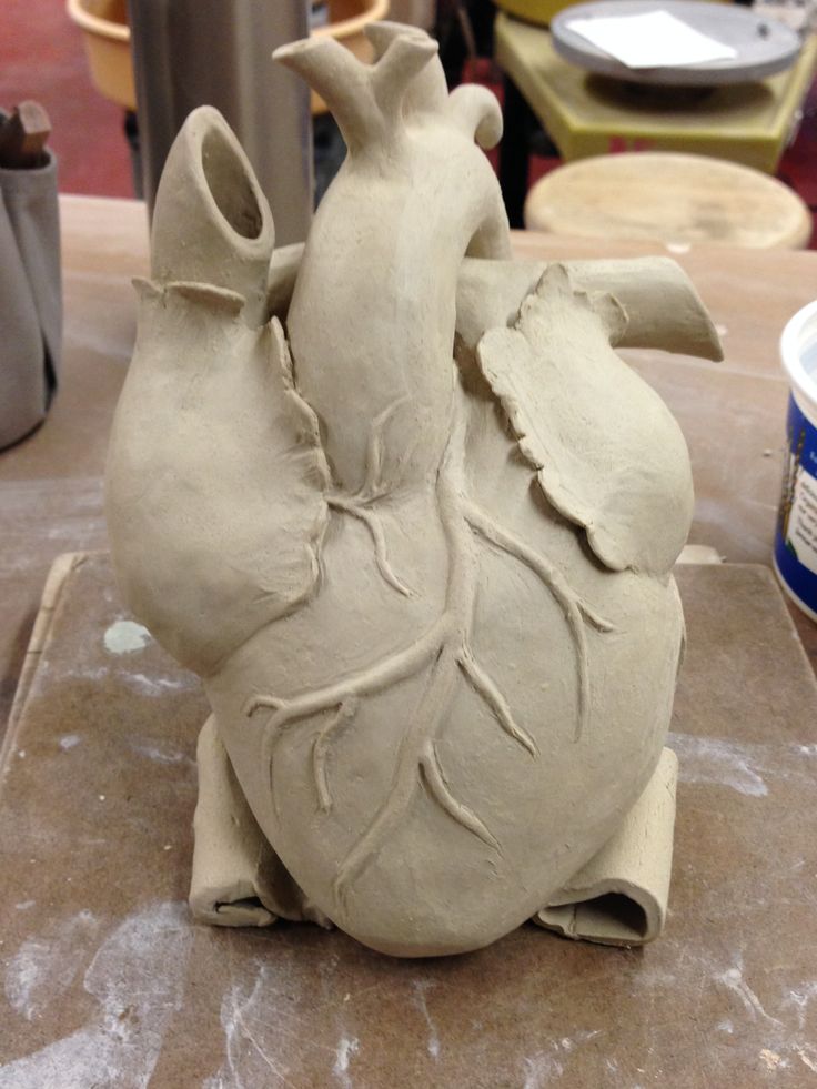 a clay heart sitting on top of a table