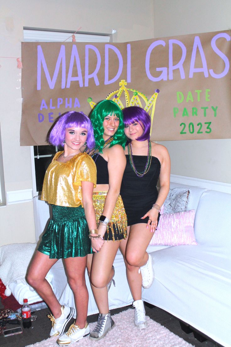 three young women dressed up in costumes posing for the camera at mardi gras