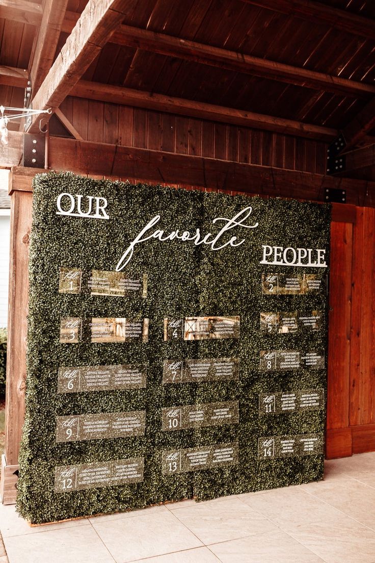 a sign that says our favorite people is on display in front of a wooden building