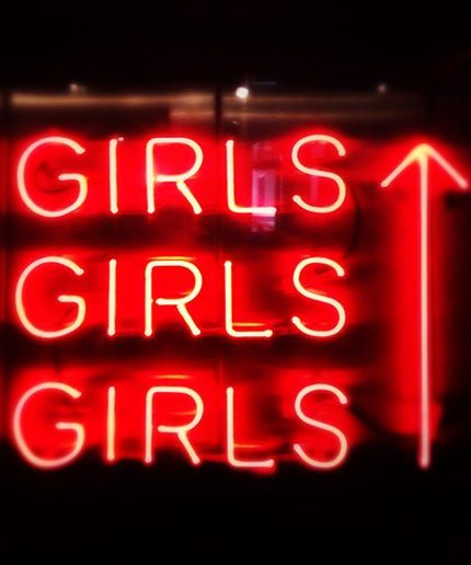 a red neon sign that says girls only