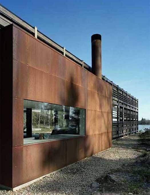 an exterior view of a building that is made out of wood and metal with windows