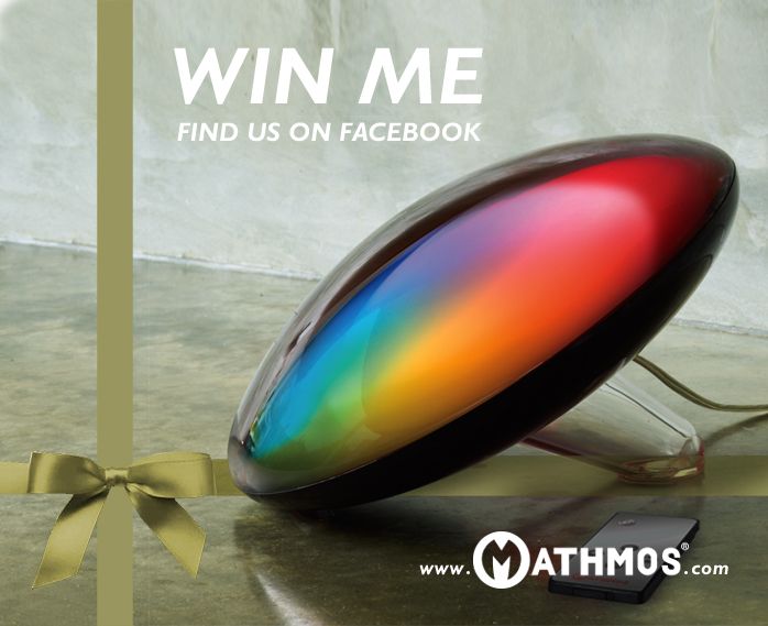 a rainbow colored object sitting on top of a table next to a yellow ribbon with the words, win me find us on facebook