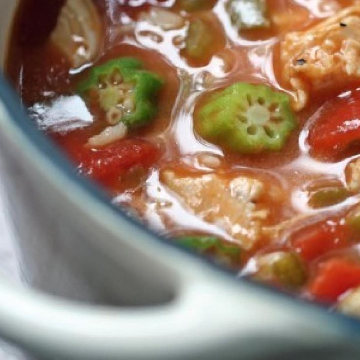 a pot filled with soup and vegetables on top of a table