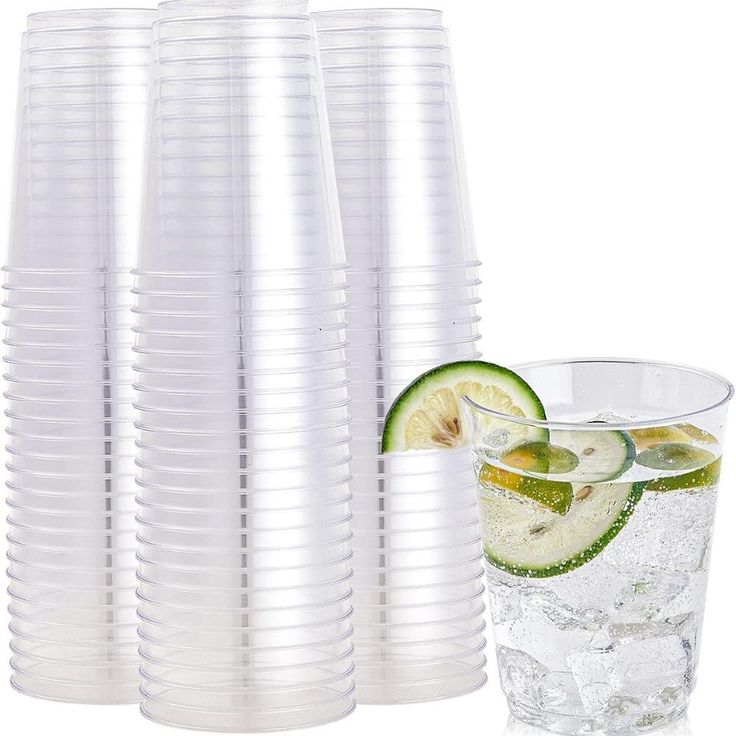 there are many glasses with water and limes in them