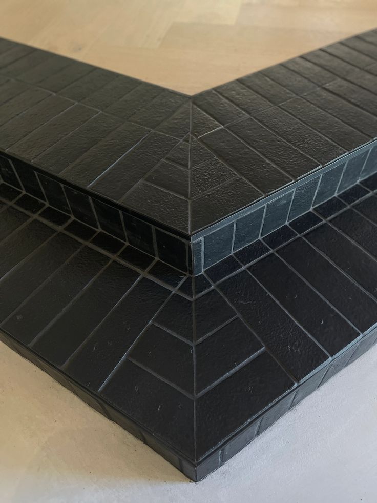 two black tiles sitting on top of each other