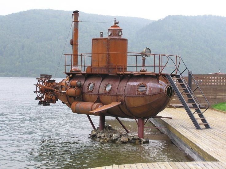 a large boat sitting on top of a body of water next to a wooden dock