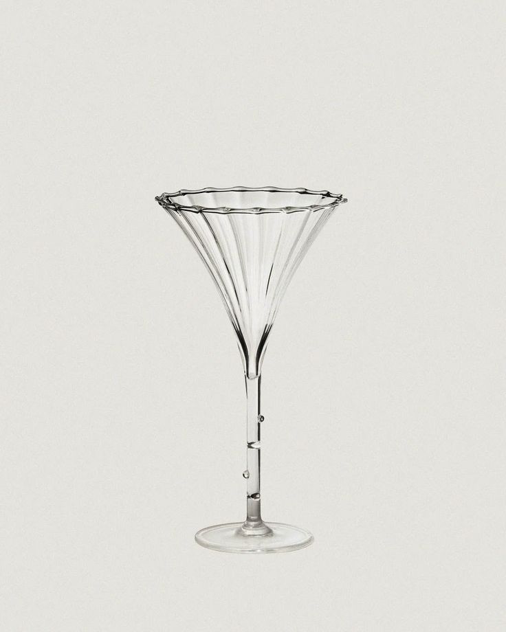 an empty wine glass sitting on top of a table