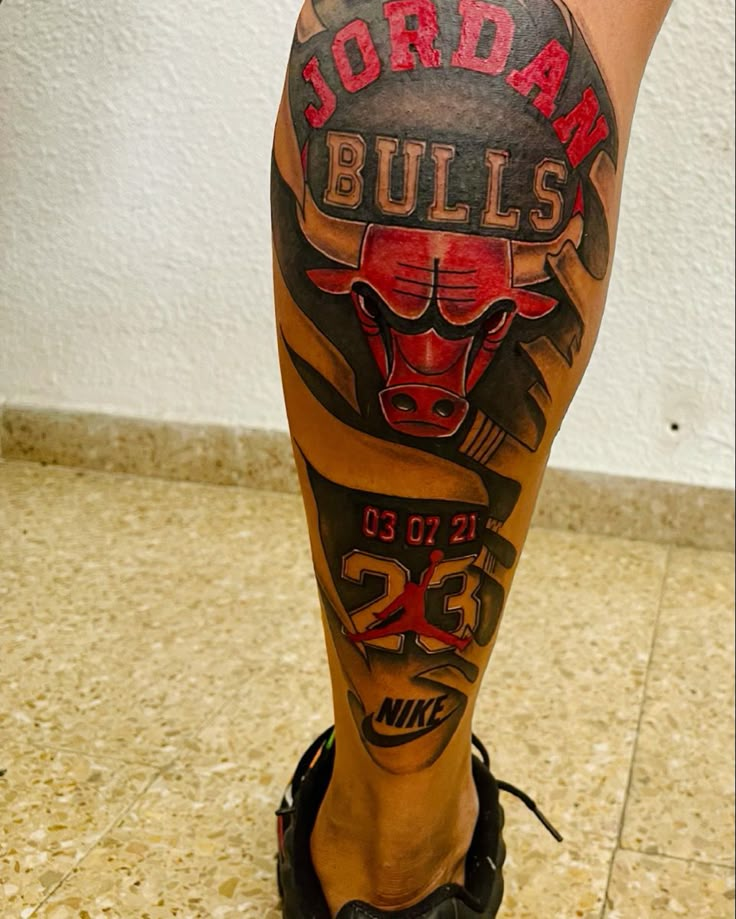 the legs and ankles of a man with tattoos on them, wearing black shoes that read jordan bulls