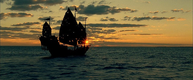 an image of a pirate ship in the ocean at sunset with words written below it