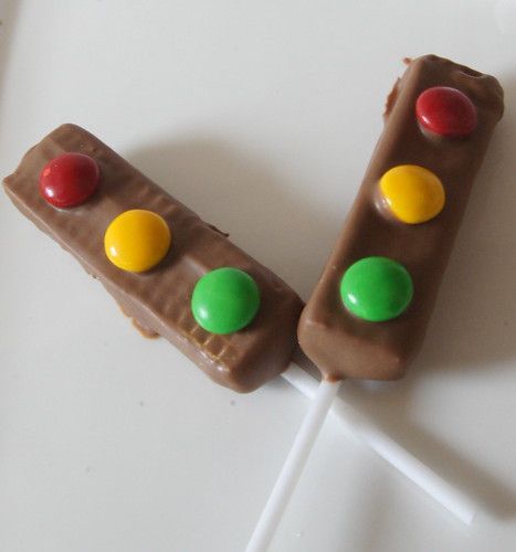 two pieces of chocolate with candies on them sitting on top of a white counter