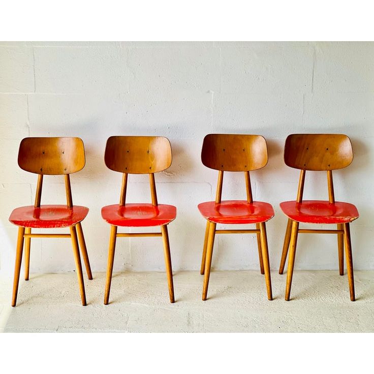 three red chairs sitting next to each other