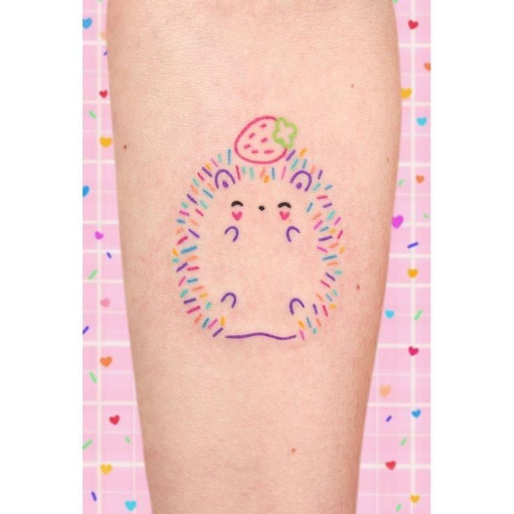 a small tattoo on the leg of a person with sprinkles around it