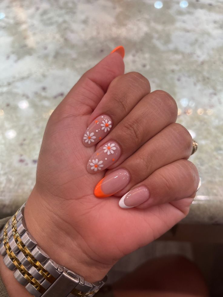 summer nails #flowers #orange #almondnails Summery Flowery Nails, Pastel Orange Nails With Flowers, Orange Nails White Flowers, Orange And Flower Nails, Almond Nails Orange French Tip, Orange And White Short Nails, Orange Nails Acrylic Square, Summer French Tips With Flowers, White And Orange French Tip Nails