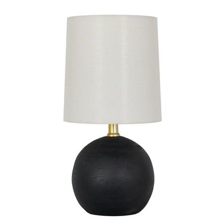 a black and gold table lamp with a white shade on the top, against a white background