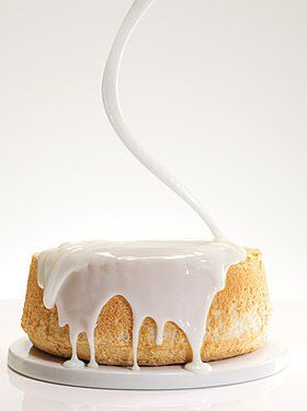 a bundt cake with icing on a white plate