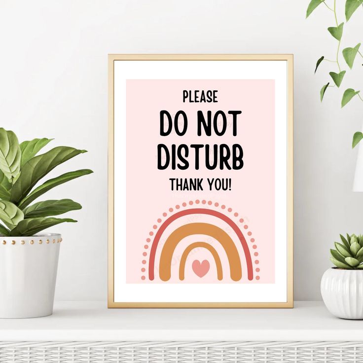 a pink poster with the words please do not disturb thank you on it next to a potted plant