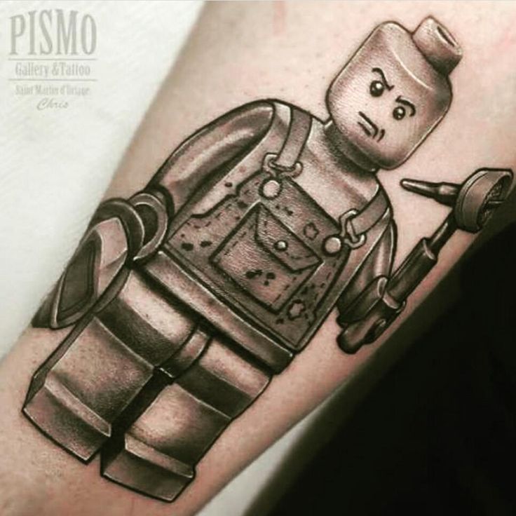 a black and white tattoo of a robot holding a wrench