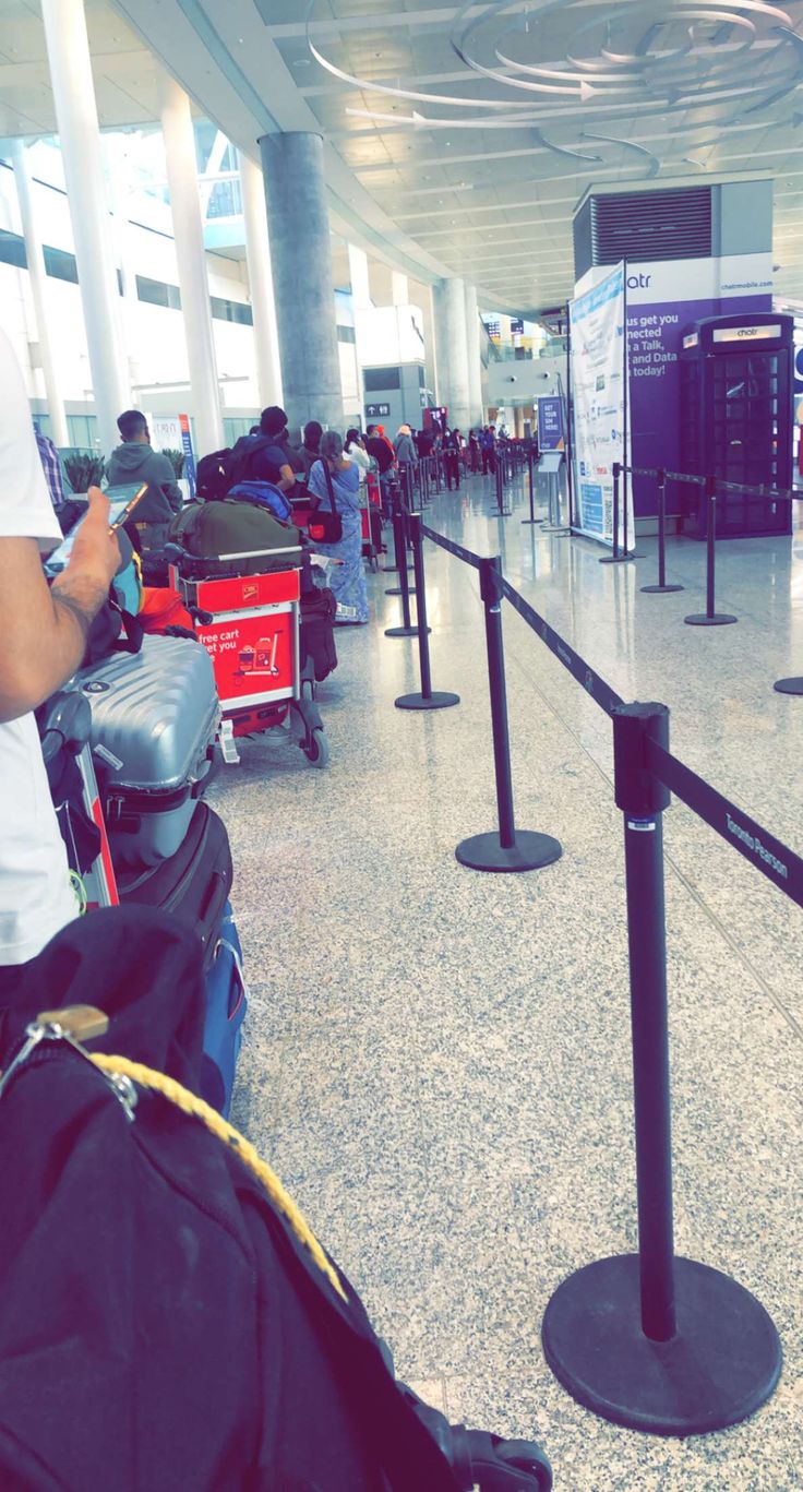 people are waiting for their luggage at the airport