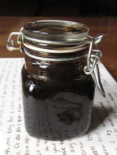 a glass jar sitting on top of a piece of paper