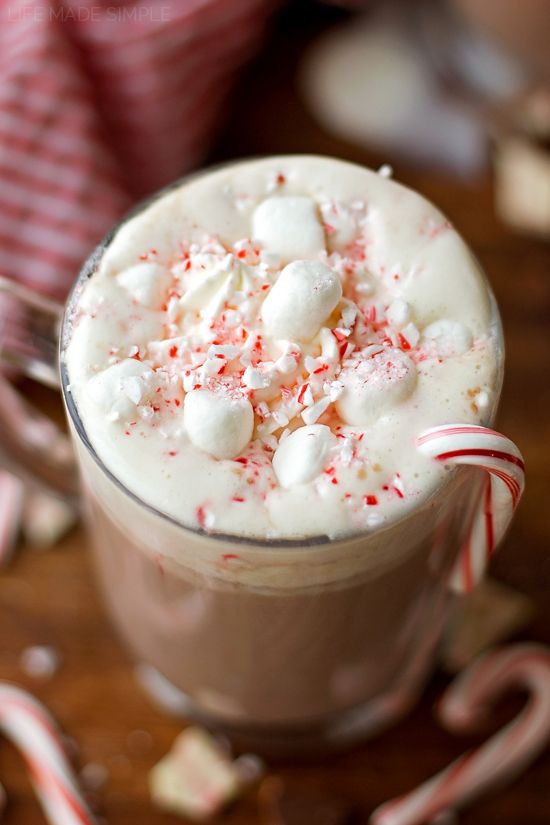 a hot chocolate drink with marshmallows and candy cane