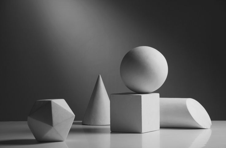 three white sculptures sitting on top of a table