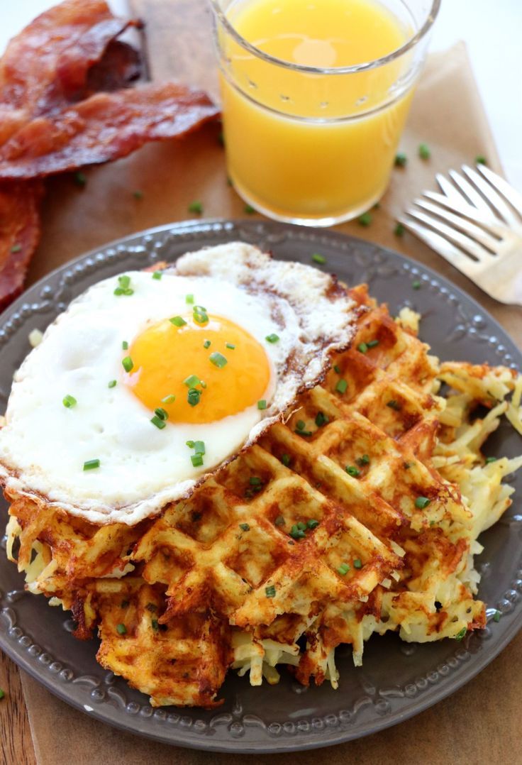 waffles with eggs and bacon on a plate