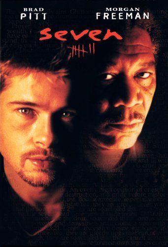 the movie seven features two men staring at each other, one with his head on another man's shoulder