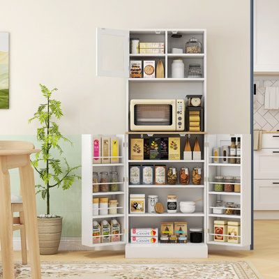 a kitchen with white cabinets and shelves filled with food