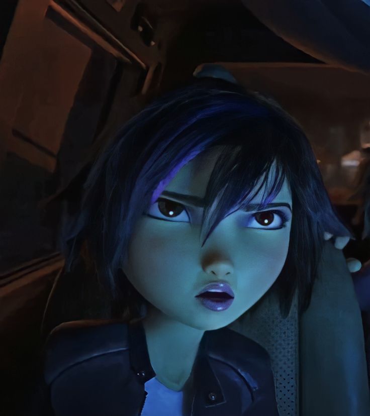 an animated character with dark hair and blue eyes sitting in a car looking at the camera