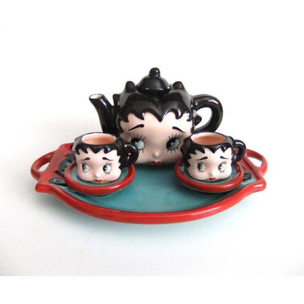 a tea set with two cups and saucers on a tray next to each other