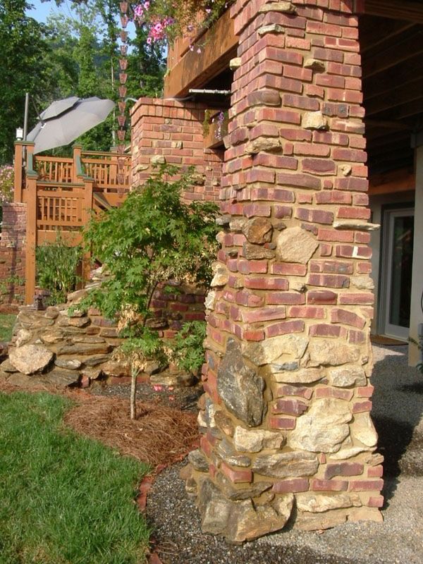 a brick building with plants growing out of it