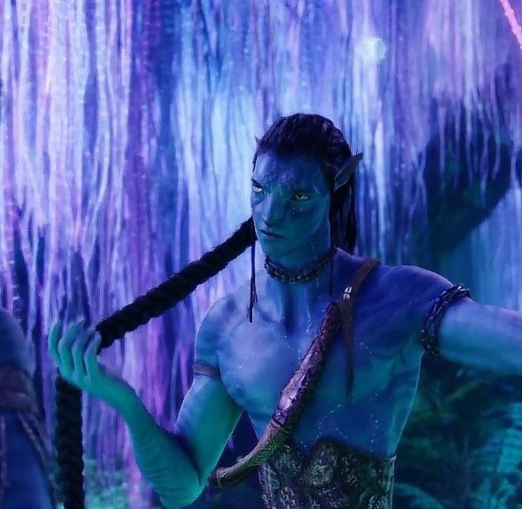 a man dressed as avatar from avatar holding two swords in front of his face and body